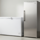 Side-by-side comparison of a chest vs upright freezer in a home utility room