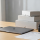 Refurbished smartphone, laptop, and camera on a desk illustrating is refurbished electronics worth it