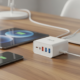 USB-C charger wattage guide illustrated by a GaN charger powering a phone, tablet, and laptop simultaneously