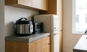 Compact multi-cooker, toaster oven, and mini fridge showing small kitchen appliances for apartments