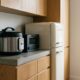 Compact multi-cooker, toaster oven, and mini fridge showing small kitchen appliances for apartments