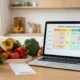Smartphone and laptop showing AI meal planning apps with grocery list and weekly menu on a kitchen counter