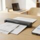 A compact handheld device representing one of the best portable document scanners scanning a paper receipt on a desk