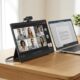 Portable monitor for video calls set up next to a laptop with a webcam mounted on top in a home office