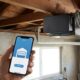 Smart garage controller mounted on a garage door opener, one of the best smart garage controllers for retrofitting older garages