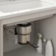 Garbage disposal humming not working being reset with an Allen wrench under a kitchen sink