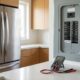Stainless-steel refrigerator and circuit breaker panel illustrating how many amps does a refrigerator use