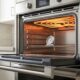 Oven takes long to preheat due to worn heating element visible inside open oven