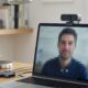 Webcam keeps freezing during a video call shown on a laptop screen with a USB hub nearby
